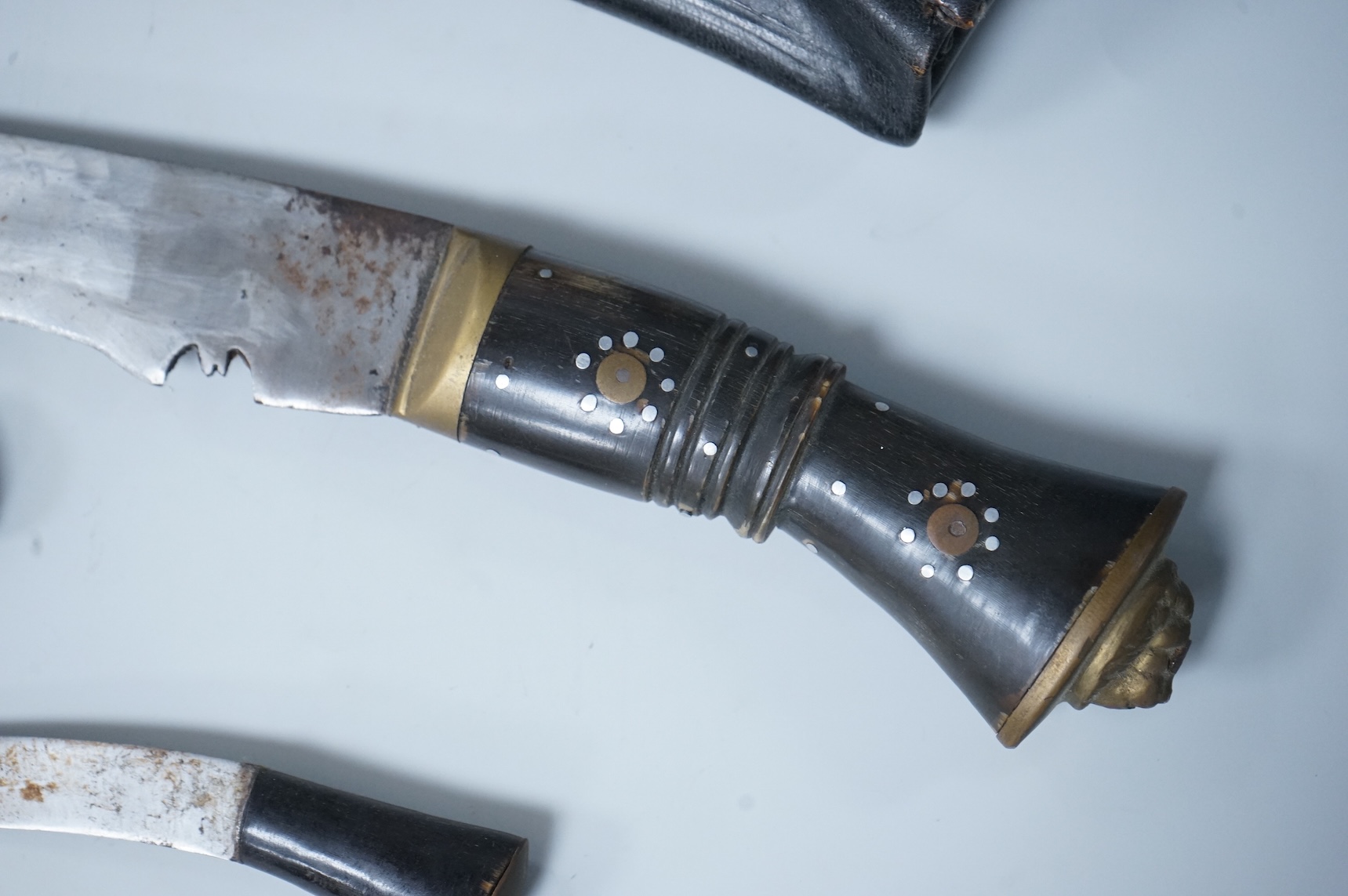 Two kukri knives in leather covered scabbards